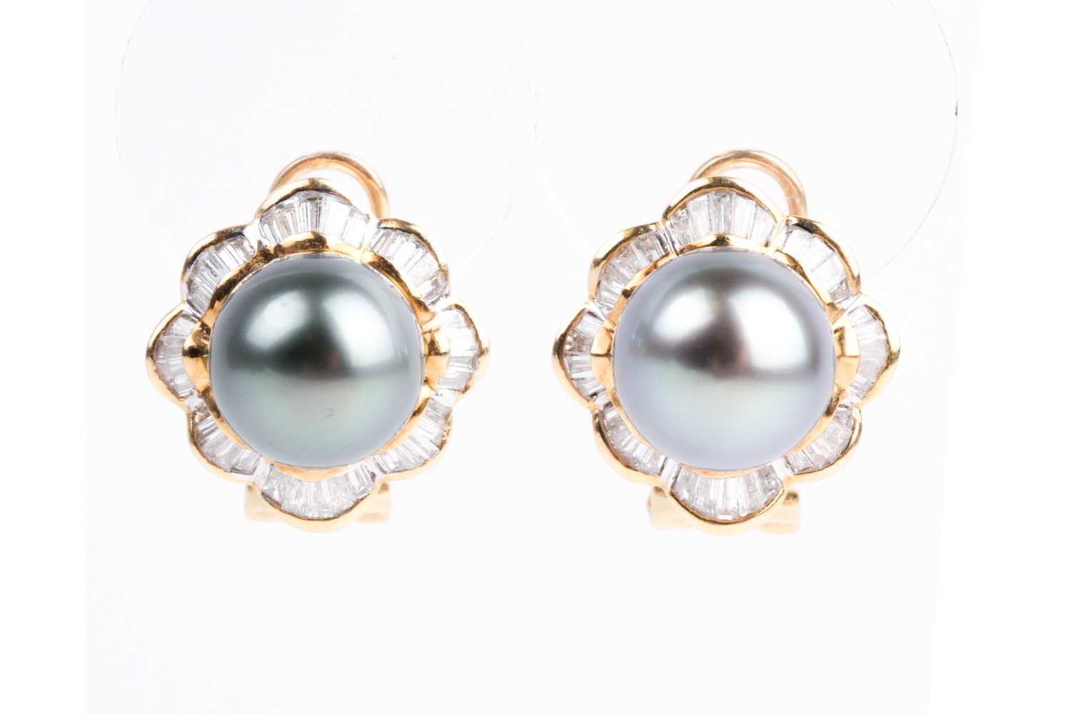 A pair of Tahitian grey pearl and baguette diamond cluster earrings, the central pearls within a