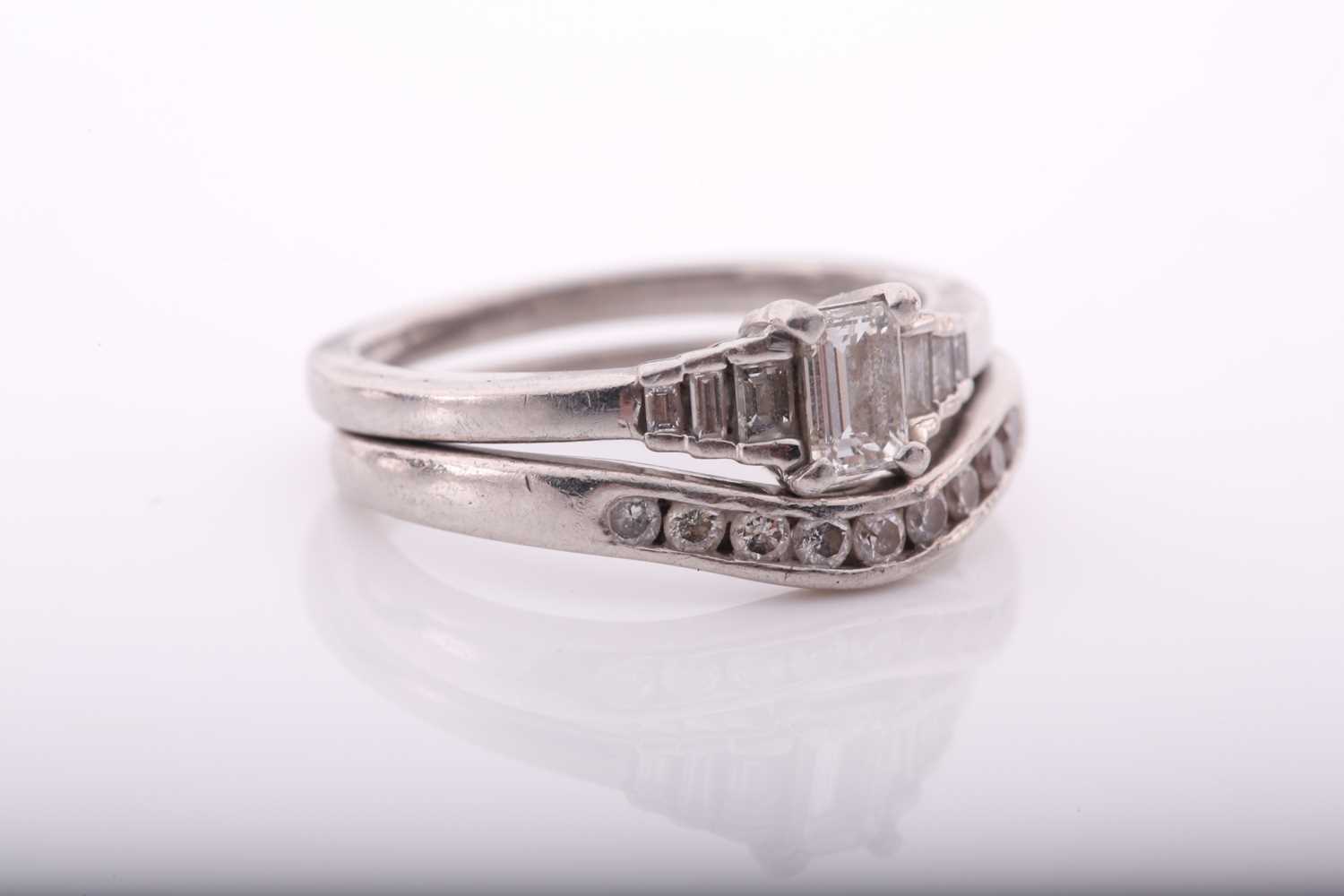 A platinum and diamond ring, set with an emerald-cut diamond of approximately 0.32 carats, the - Image 3 of 7