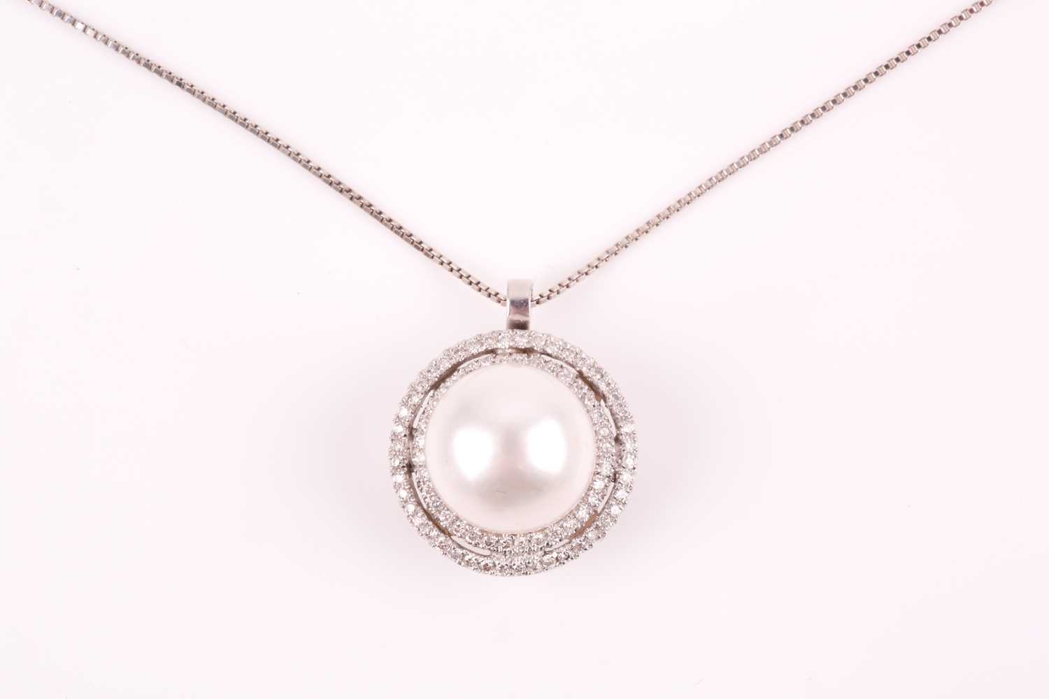 A diamond and pearl pendant, the round white pearl within a double halo border of round-cut