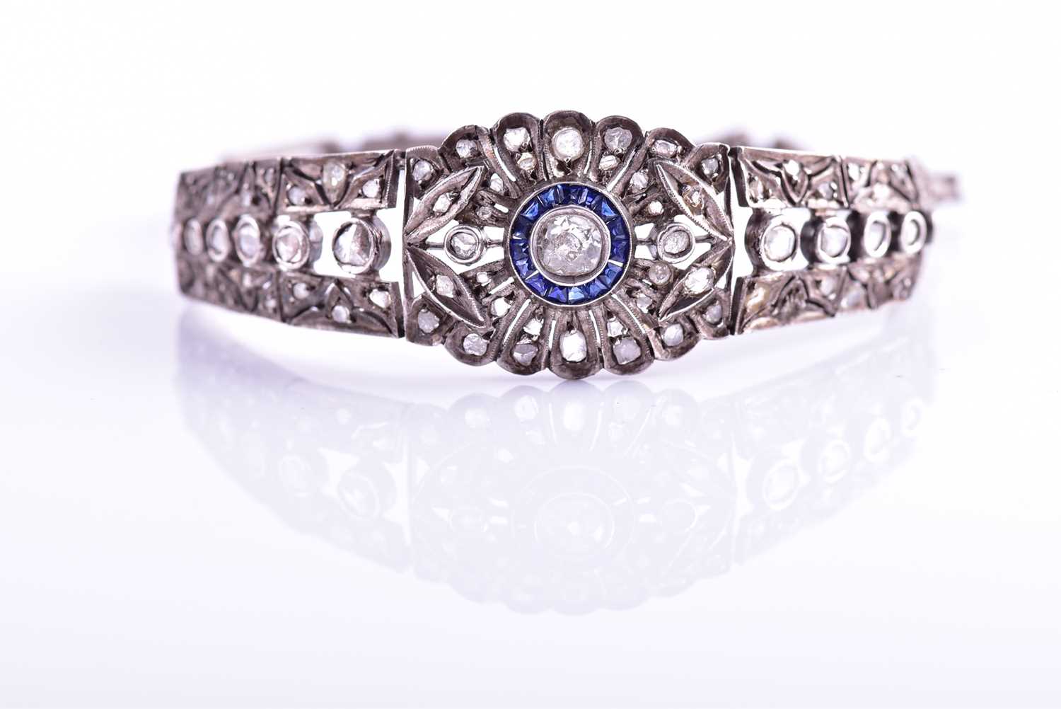 An early 20th century diamond and sapphire bracelet, the articulated mount centred with an old-cut