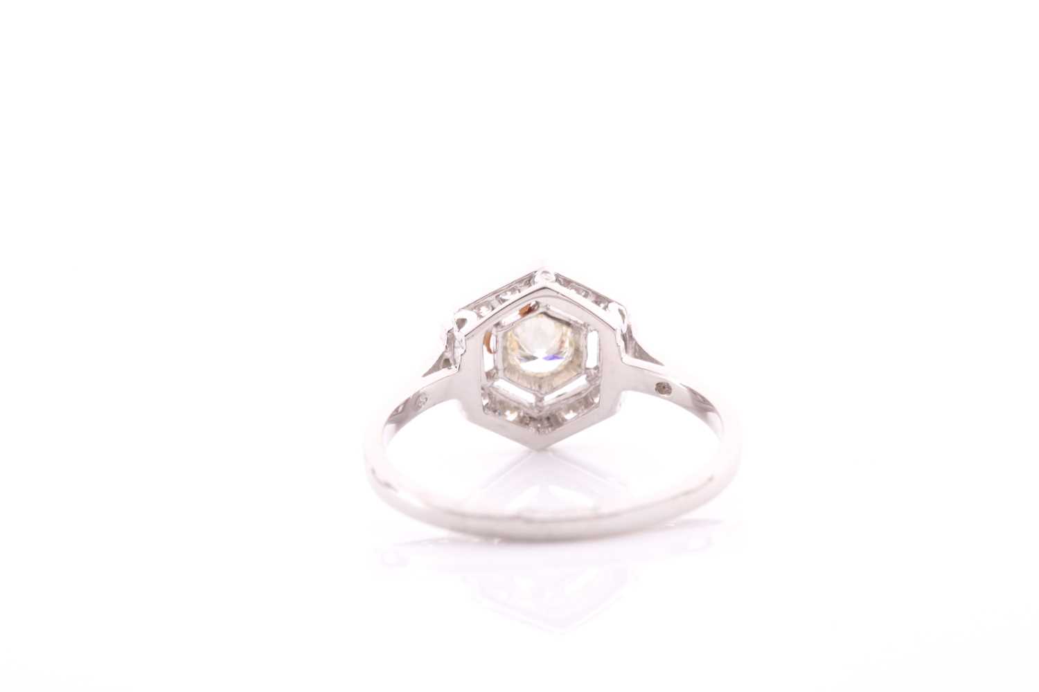 A platinum and diamond ring of hexagonal design, centred with a round brilliant-cut diamond within a - Image 3 of 4