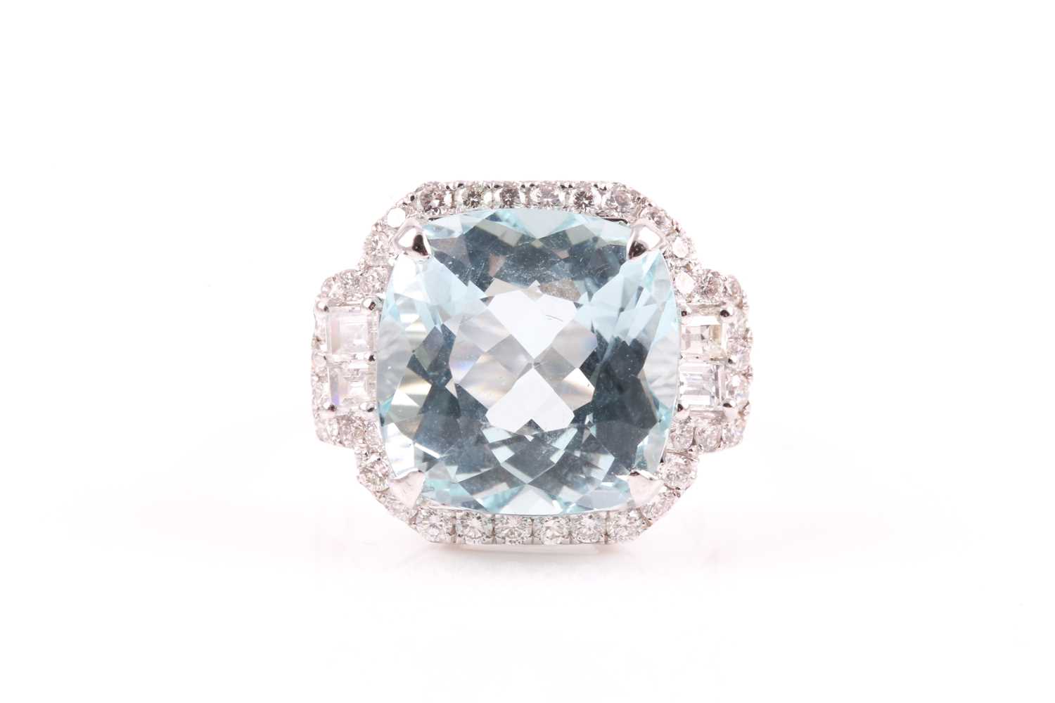 A diamond and aquamarine cocktail ring, set with a cushion-cut aquamarine of approximately 9.90