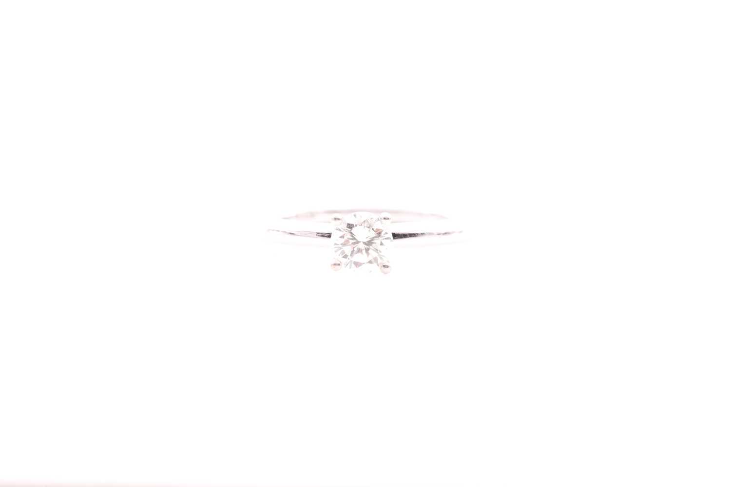 An 18ct white gold and solitaire diamond ring, set with a round brilliant-cut diamond, approximate