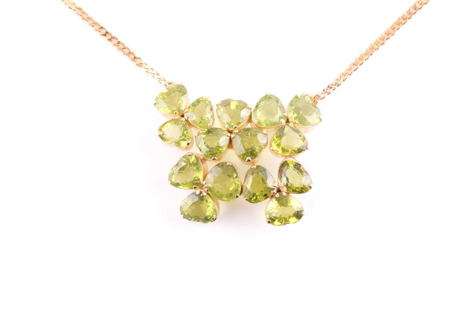 A peridot pendant; with centre composed of five three stone foliate clusters each set with the heart