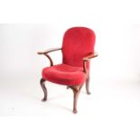 A George II style walnut library armchair with stuff over upholstery and shaped broad crook arms