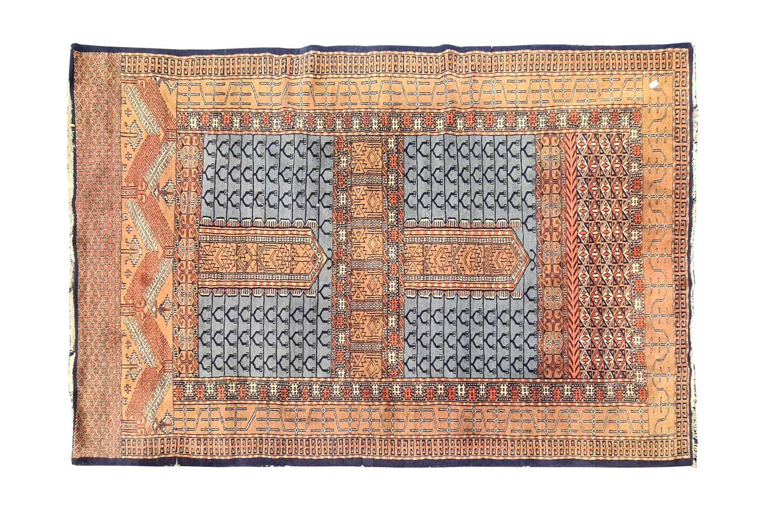 A 20th century pale blue ground Turkoman style Hatchli rug. With two central panels of forked