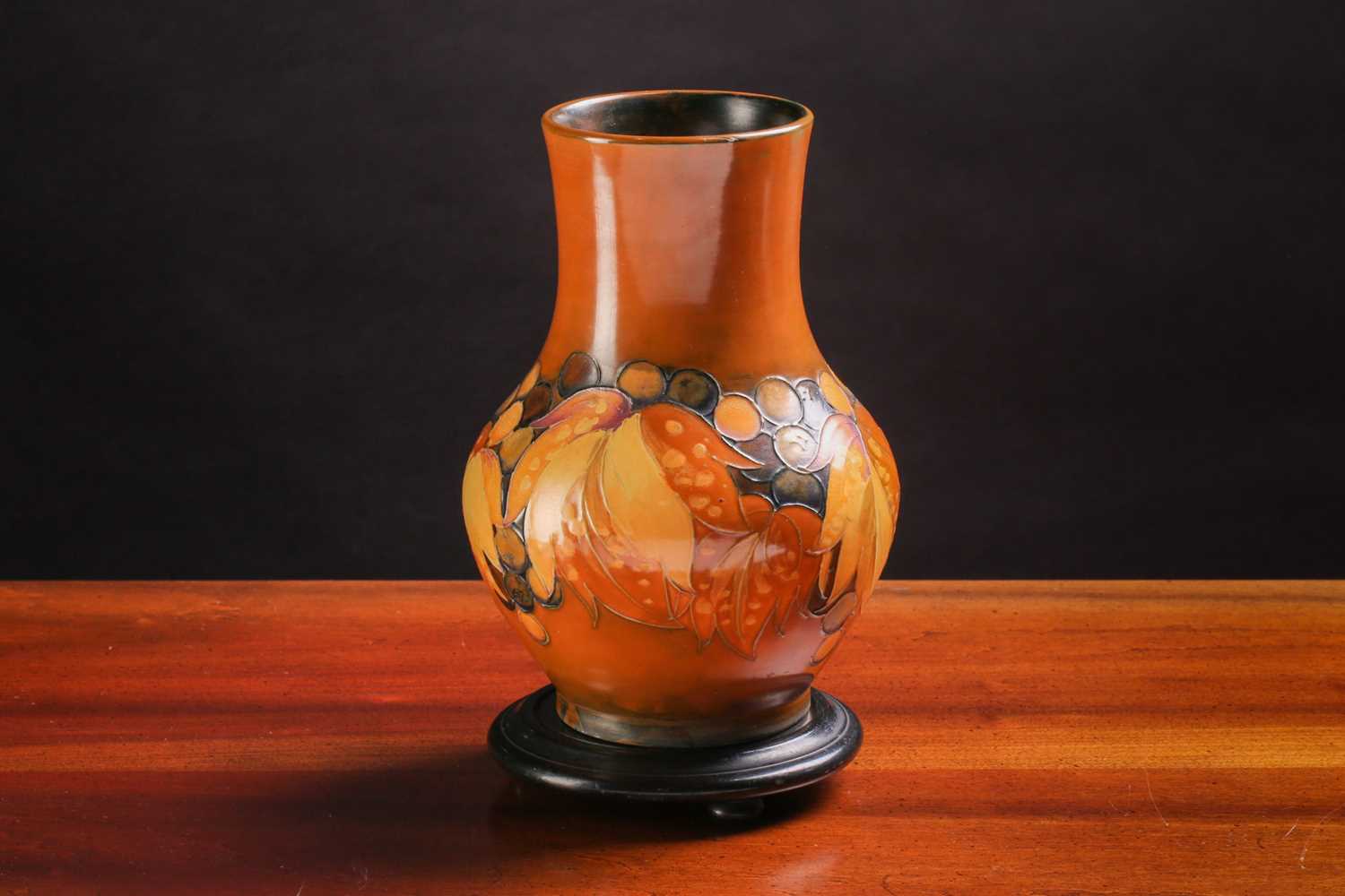 A mid-century Moorcroft baluster vase, in the Leaf & Berry pattern on brown/yellow ground, impressed