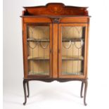 An early 20th century inlaid mahogany display cabinet. With a pair of leaded glazed doors on