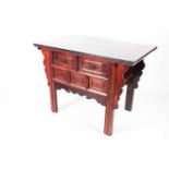 A 20th century stained and lacquered elm altar table with two frieze drawers supported on shaped