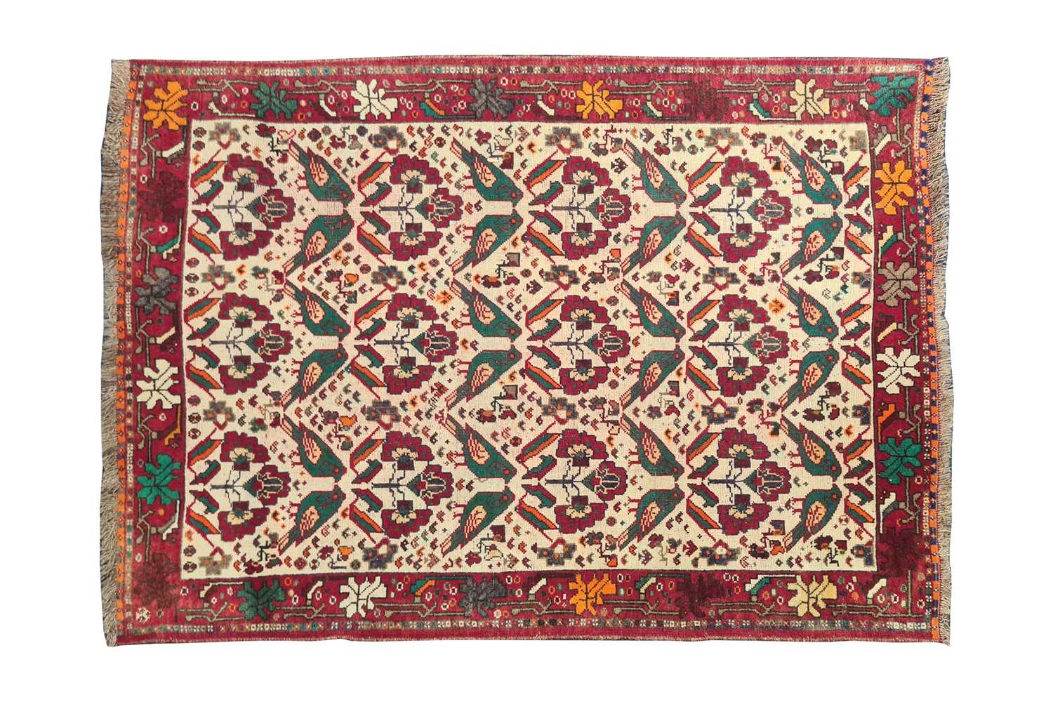 A 20th century ivory ground Baktiari rug with stylized bird decoration within geometric border.153cm