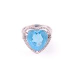 A blue topaz and diamond heart-shaped cluster ring; the diamond faceted topaz, in three claw mount