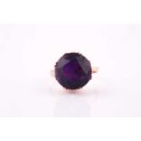 A 1960's amethyst solitaire ring, the round brilliant cut amethyst, approximately 10 carats, set