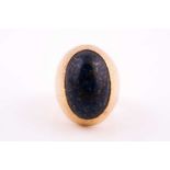 Grima. An 18ct yellow gold and lapis lazuli ring, set with an oval cabochon lapis, raised in a