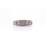 A platinum and diamond ring, the five graduated round brilliant-cut stones set in squared mounts,