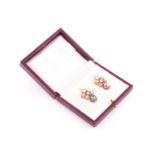 A pair of yellow metal, rose-cut diamond, and natural saltwater pearl earrings, each set with six