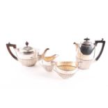A matched four piece silver tea and coffee set; Teapot London 1899 by The Goldsmiths &