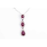 A triple cluster ruby, diamond and kunzite pendant, the graduated oval cabochon rubies in
