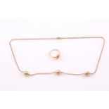 Cartier. An 18ct yellow gold necklace, set with three white and yellow gold twisted beads, on a