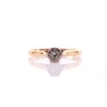An 18ct yellow gold and diamond ring, illusion-set with a small round brilliant-cut diamond of