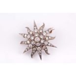 A late 19th / early 20th centuy diamond starburst brooch, inset with round-cut diamonds, silvered
