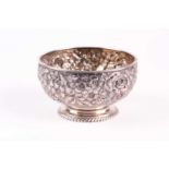 A late 19th century American sterling silver footed bowl, possibly by Gorham, with repousse floral