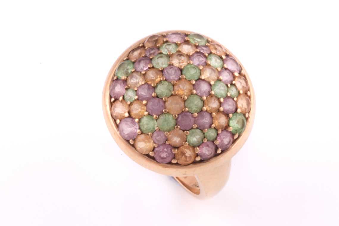 A multi gem-set dress ring; the domed cluster set with multi-coloured pink, amber and green gem