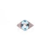 A 14ct white gold, diamond, and aquamarine ring, set with a mixed oval-cut aquamarine of
