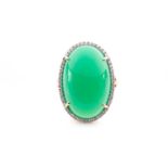 A 14ct yellow gold and green agate cocktail ring, the oval cabochon agate within a border of round