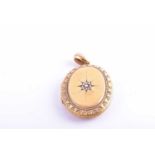A Victorian yellow metal locket pendant, the hinged lid with starburst design inset with split