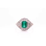 An 18ct yellow gold, diamond and emerald ring, set with an emerald-cut emerald within an openwork