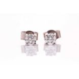 A pair of 18ct white gold and solitaire diamond earrings, of approximately 0.32 carats combined,