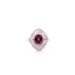 A platinum, diamond, and ruby ring, set with a oval brilliant-cut reddish purple ruby, surrounded