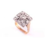 An Art Deco diamond ring; the nine stone openwork square diamond plaque set with brilliant cut