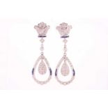 A pair of sapphire and diamond pendant earrings; with fleur de lys style surmount suspending