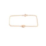 An 18ct yellow gold bracelet, with a small oval pendant loop inset with a small white stone, 18 cm