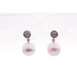 A pair of diamond and pearl drop earrings, each with a South Sea pearl measuring approximately 11 mm