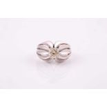 A 1950's solitaire diamond ring, set in white metal with pierced raised shoulders and fluted