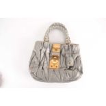 A Miu Miu grey/green leather handbag, the catch with a lock, and key in leather pouch attached to