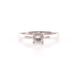 A single stone diamond ring, the round brilliant cut diamond in simple raised claw mount; to