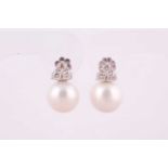 A pair of South Sea pearl and diamond stud earrings, each with three brilliant cut diamonds, total