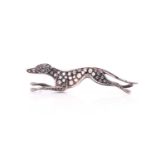 A silver gilt and diamond novelty brooch in the form of a leaping greyhound, the body inset with