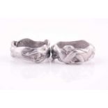 A novelty pair of aluminium erotic rings, sizes P and U. (2)