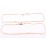 A cultured pearl necklace with white metal clasp, together with a smaller cultured pearl necklace