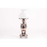 A 19th-century silver plated through draft oil lamp. With milk glass shade over a segmented body