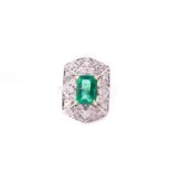 An 18ct white gold, diamond, and emerald plaque ring, set with an emerald-cut emerald of