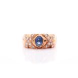 An 18ct yellow gold, diamond, and sapphire ring, collet-set with a mixed oval-cut sapphire,