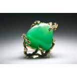 A 14ct yellow gold and green chalcedony ring, the naturalistic mount set with a tumbled green stone,