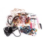 A quantity of beaded necklaces and bracelets including a tigers eye necklace with heart shaped