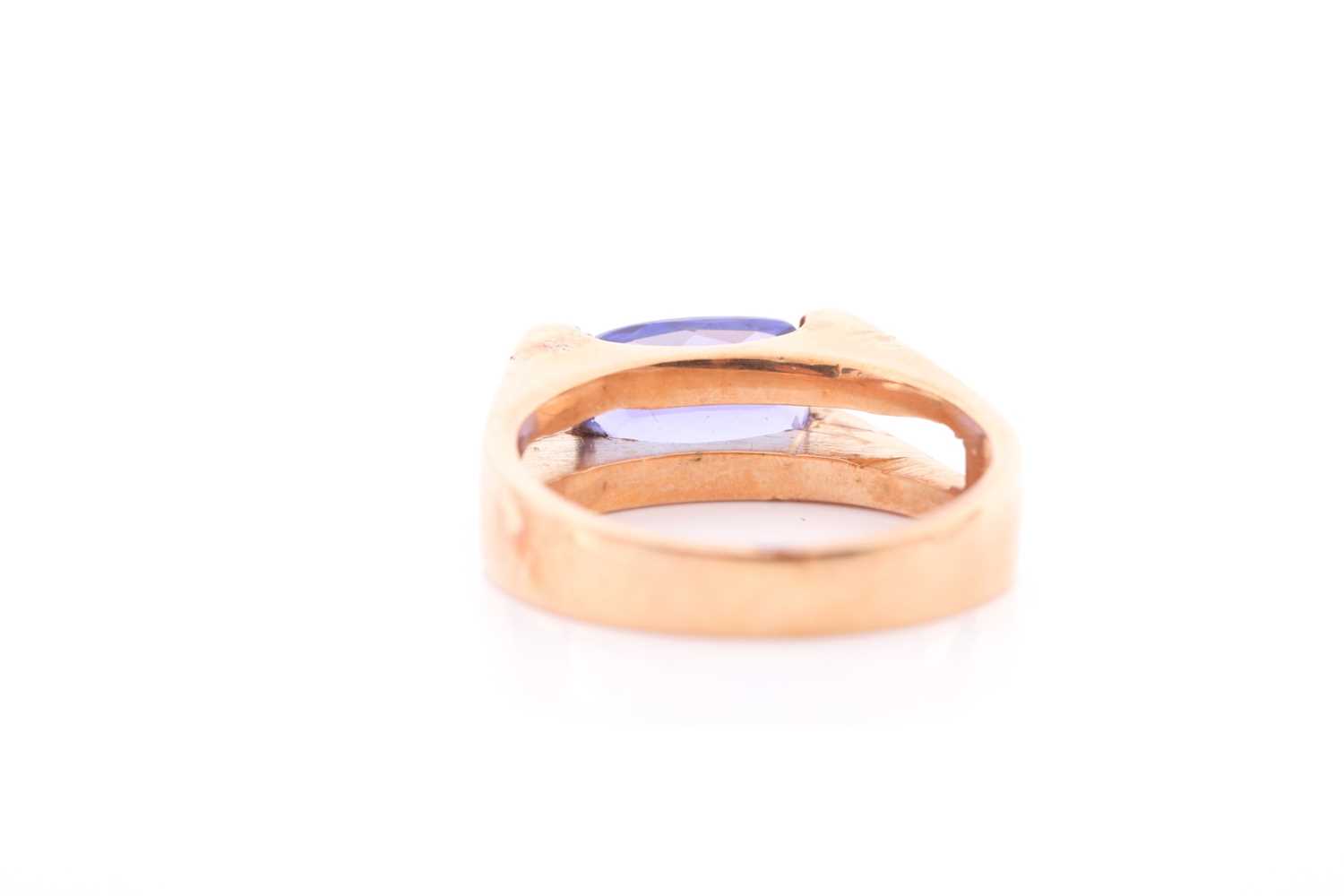 An 18ct yellow gold and tanzanite ring, set east to west with a rectangular mixed-cut tanzanite, - Image 4 of 4