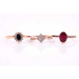 A single stone oval ruby ring, with diamond set shoulders; a four stone square diamond cluster ring,
